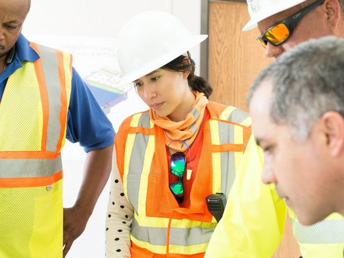 Female Keller project manager talking with colleagues